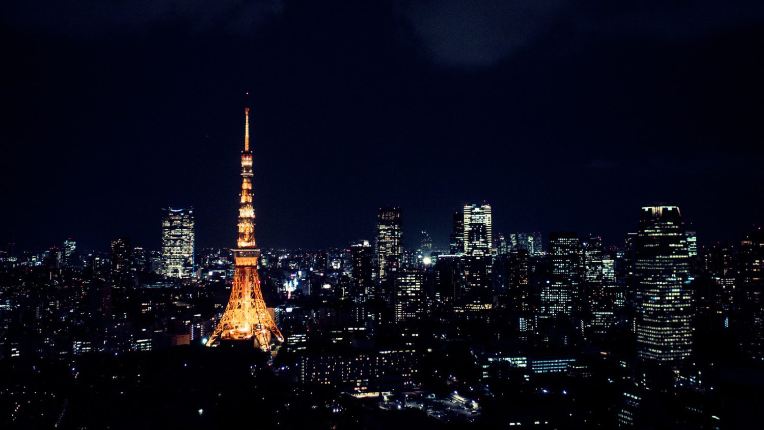 Aerial night view of Tokyo with an illuminated Tokyo Tower.